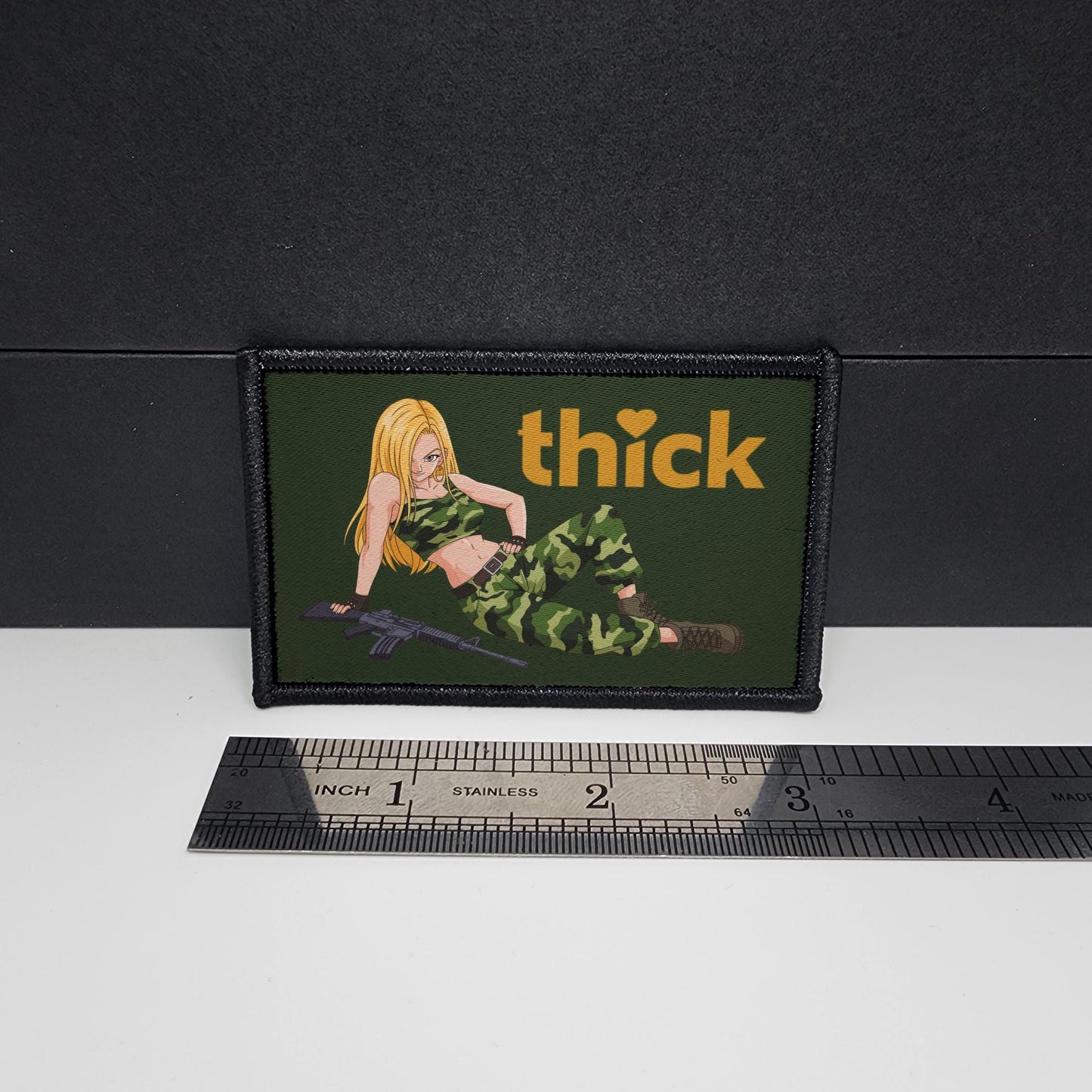 Patch with a graphic of a person in camouflage and the word 'thick' next to a ruler for scale.
Thick Hearts – morale patch – sexy - anime - waifu - video game - 2x3 inch – hook and loop - iron-on – interchangeable patch hat - army waifu