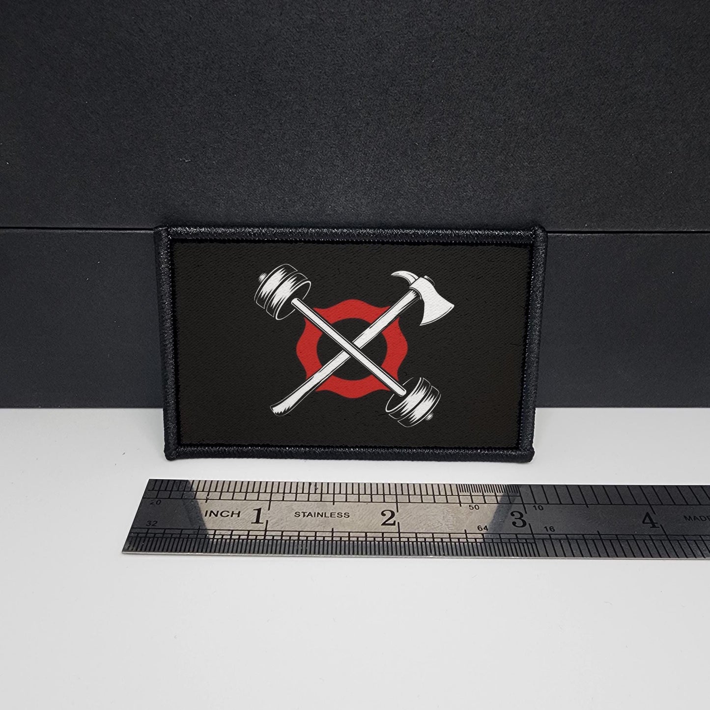 Patch with crossed axes and a red circle on a black background, next to a ruler for scale.
CAPS LOCK ORIGINAL - morale patch - 2x3 inch – hook and loop - iron-on - interchangeable patch - hat - bag -firefighter patch - fire station patch