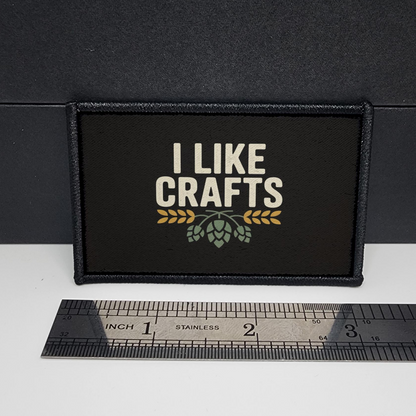Black patch with 'I Like Crafts' text on a white surface with a ruler for scale.