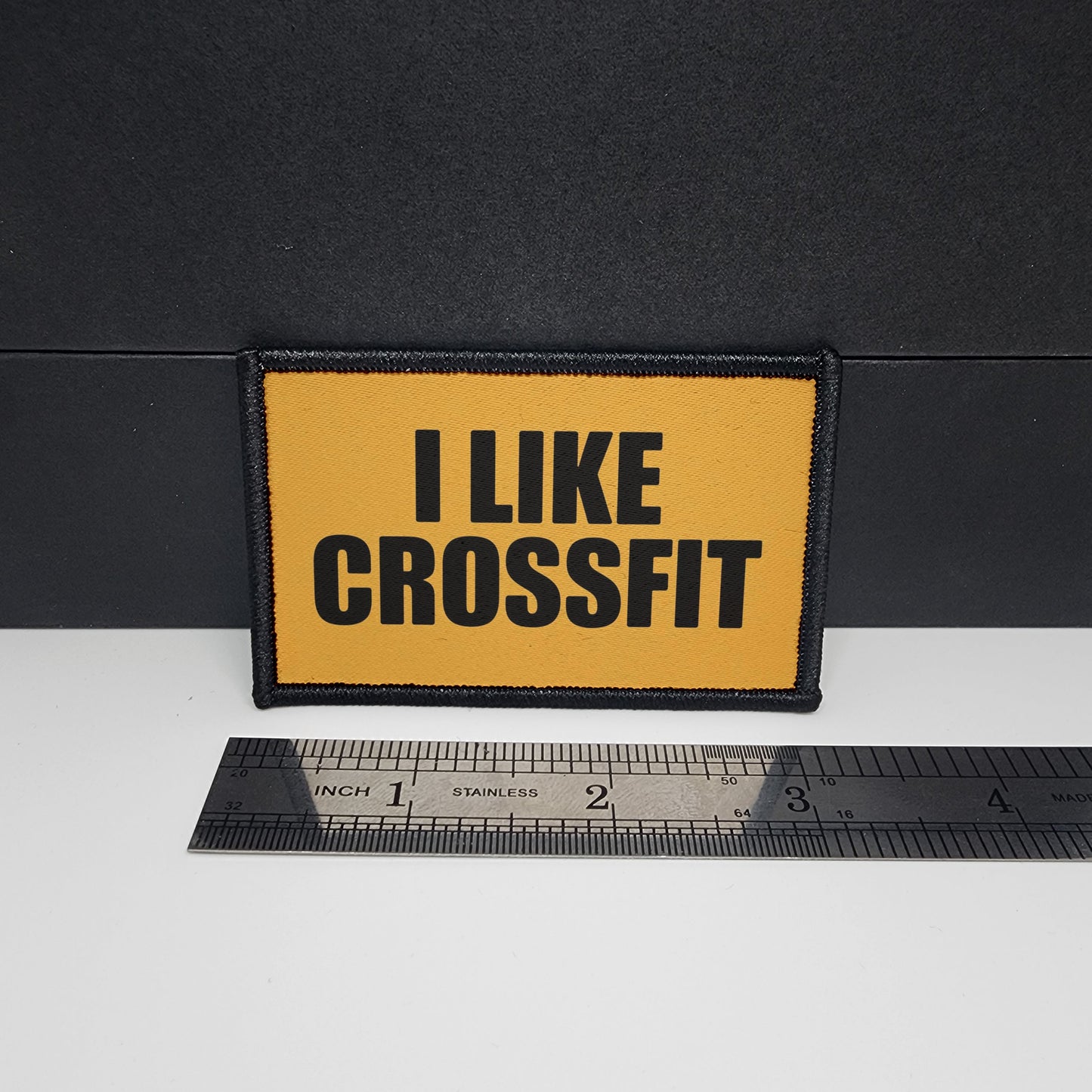 Yellow patch with 'I LIKE CROSSFIT' text on a black background, next to a ruler for scale.

CAPS LOCK ORIGINAL - morale patch - 2x3 inch – hook and loop - iron-on - interchangeable patch - hat - bag - sports