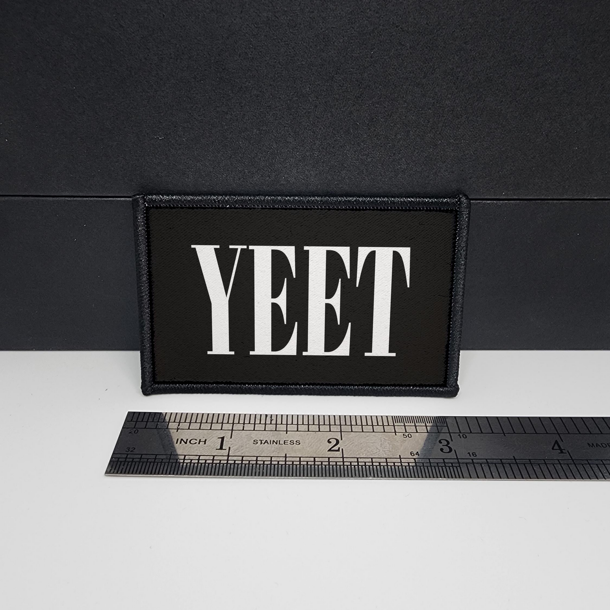 Black patch with 'YEET' text on a white surface with a ruler for scale.

CAPS LOCK ORIGINAL - morale patch - 2x3 inch – hook and loop - iron-on - interchangeable patch - hat - bag