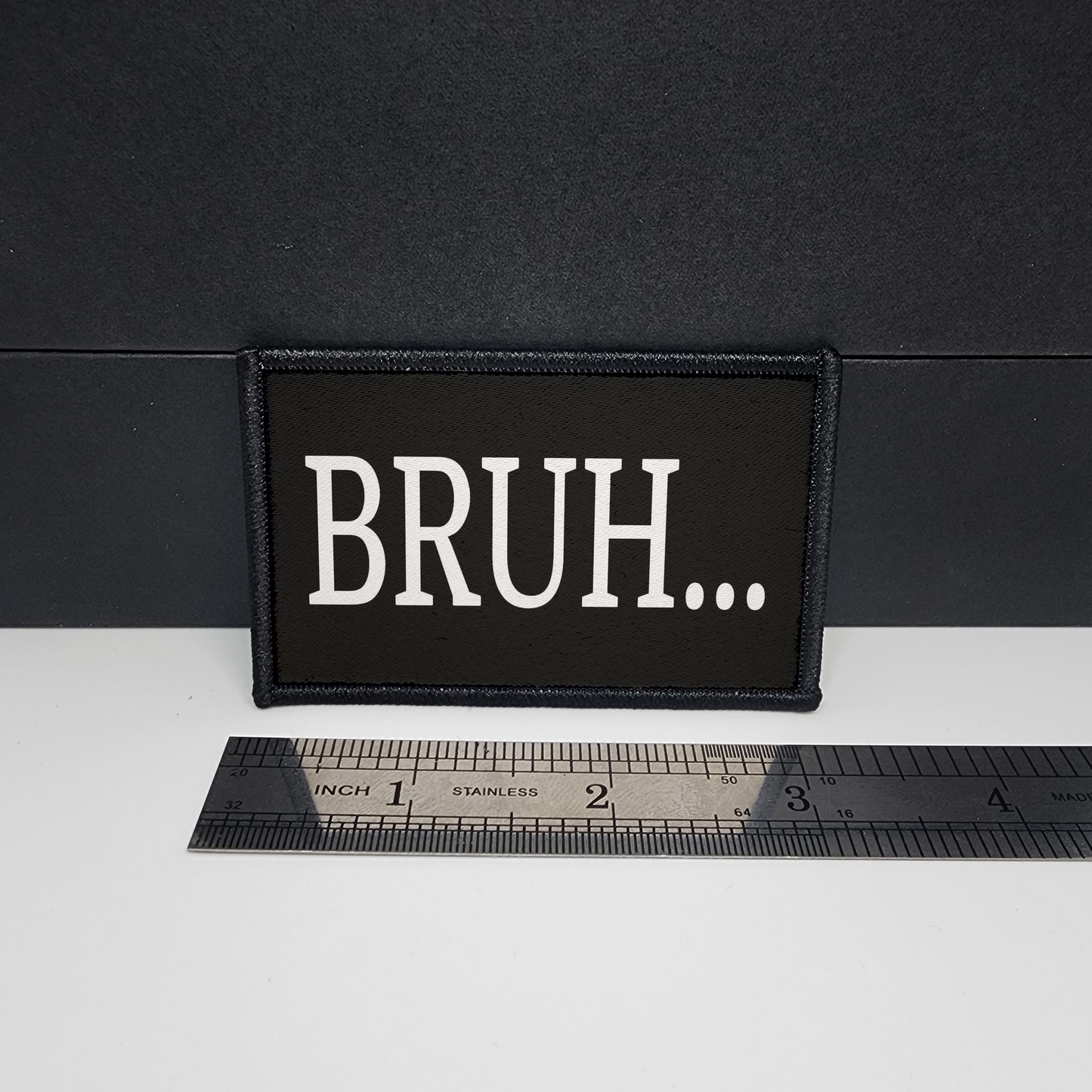 Black patch with 'BRUH...' text on a white surface with a ruler for scale.

CAPS LOCK ORIGINAL - morale patch - 2x3 inch – hook and loop - iron-on - interchangeable patch - hat - bag