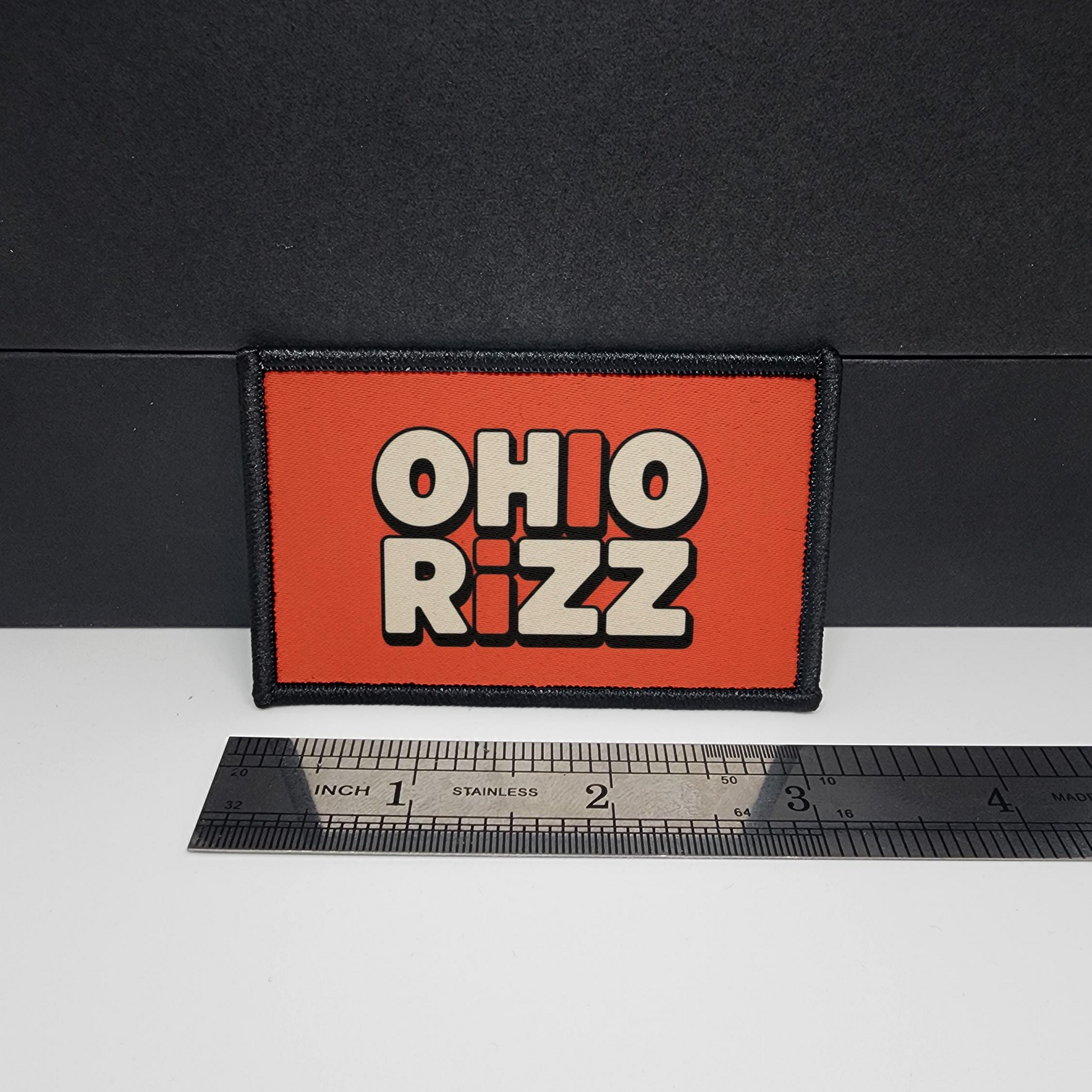 Rectangular patch with 'OHIO RIZZ' text on an orange background, placed on a white surface with a ruler for scale.

CAPS LOCK ORIGINAL - morale patch - 2x3 inch – hook and loop - iron-on - interchangeable patch - hat - bag
