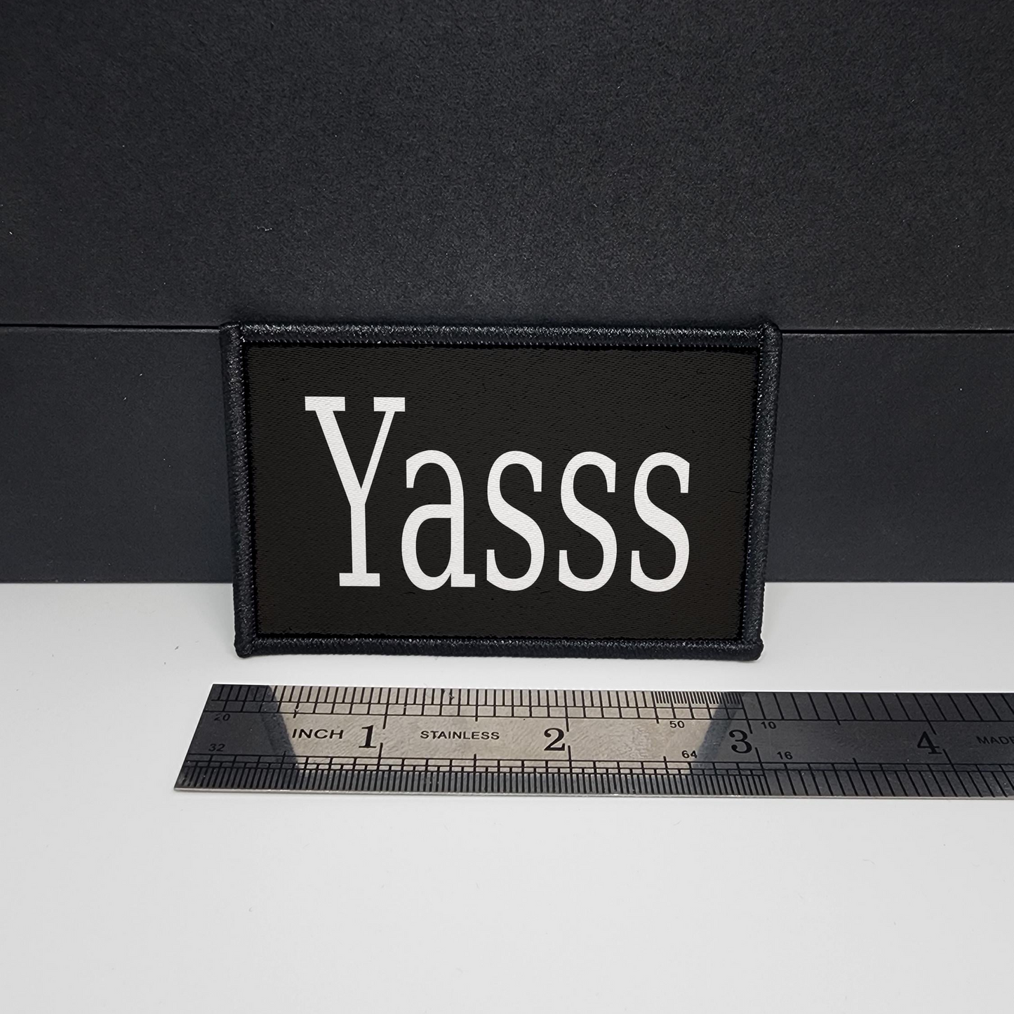 Black patch with 'Yasss' text on a white surface with a ruler for scale.

CAPS LOCK ORIGINAL - morale patch - 2x3 inch – hook and loop - iron-on - interchangeable patch - hat - bag